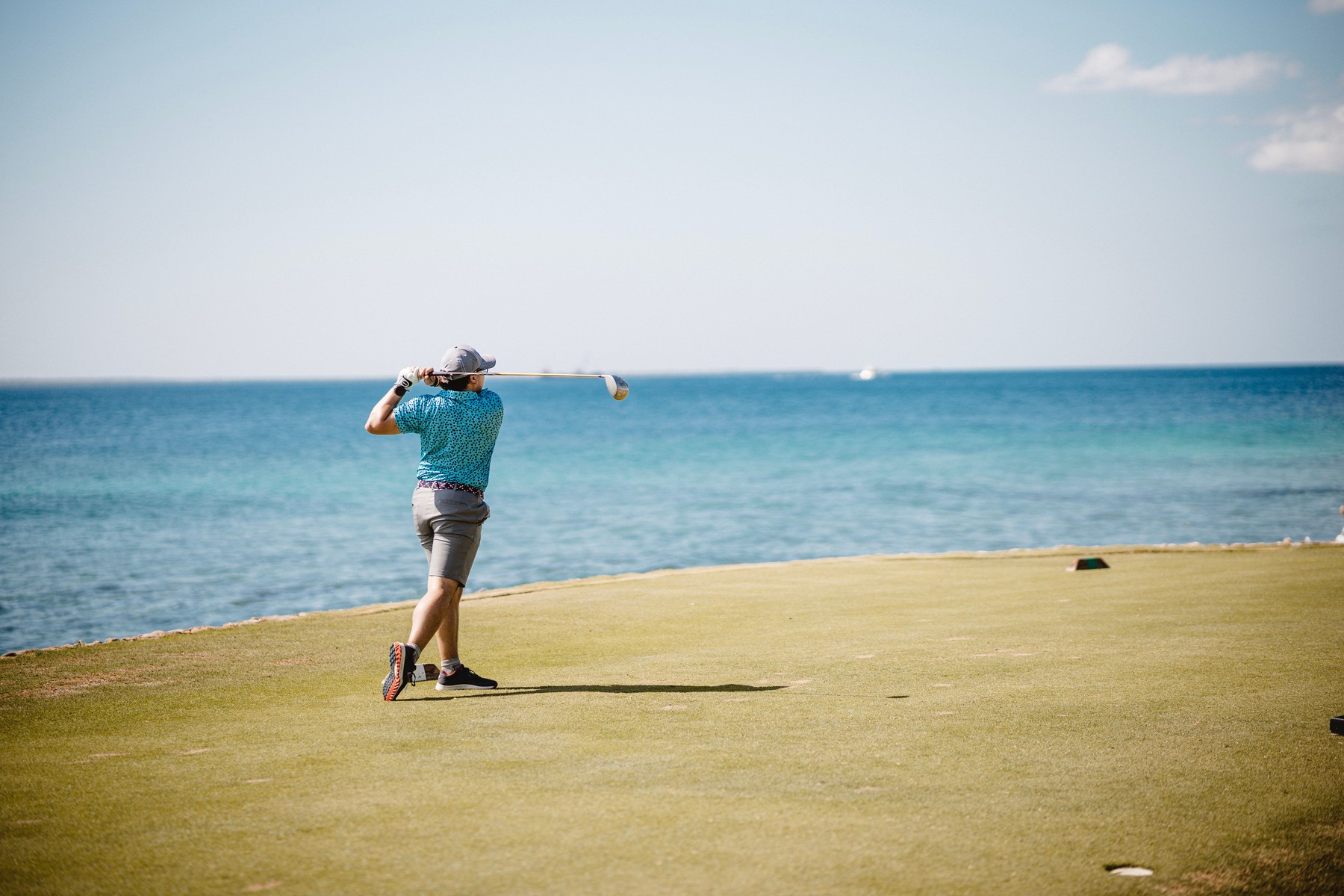 Golfer overlooking a coastal course